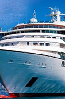 Cargo ship sailing in open sea with a cruise ship besides